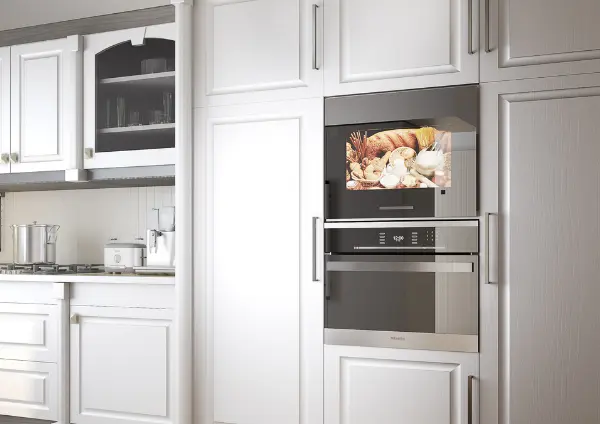 Modern all-white kitchen featuring a built-in smart kitchen TV integrated into cabinetry.